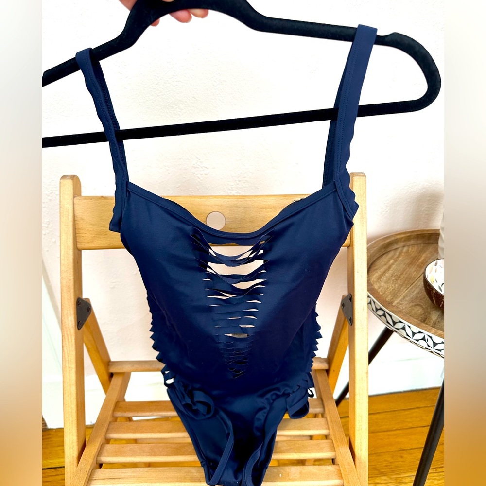 One piece swim wear with cuts on the front and sides, in size M